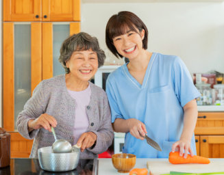 caregiver and elder woman in the kitchen